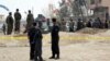 Security forces inspect the site of a suicide attack on prison employees' vehicle in Kabul, Afghanistan, Oct. 31, 2018. 