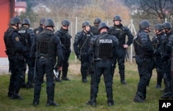 Slovenian police gather near the Croatian border in Rigonce, Slovenia, as the country beefs up security to control the migrant tide, Nov. 11, 2015.