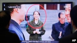 People watch a TV news program showing Kim Yo Jong, North Korean leader Kim Jong Un's younger sister, at Seoul Railway Station in Seoul, South Korea, Nov. 27, 2014. On Saturday, he promoted her to the politburo.