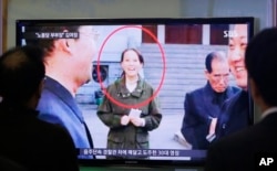 People watch a TV news program showing Kim Yo Jong, North Korean leader Kim Jong Un's younger sister, at Seoul Railway Station in Seoul, South Korea, Nov. 27, 2014. On Saturday, he promoted her to the politburo.