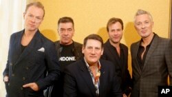 Spandau Ballet members Gary Kemp, John Keeble, Tony Hadley, Steve Norman and Martin Kemp, from left, pose for a photograph during the SXSW Music Festival in Austin, Texas, March 13, 2014. 