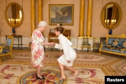 FILE - President of the Royal Academy of Dance Darcey Bussell meets Britain's Queen Elizabeth at Buckingham Palace, in central London, Britain, June 24, 2016.