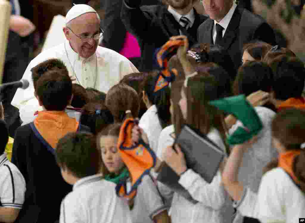 Pope Francis greets youths during an audience with students of Jesuit schools and institutions in Italy and Albania, at the Vatican. Francis got very personal as he met with thousands of children from Jesuit schools and answered their questions one by one.