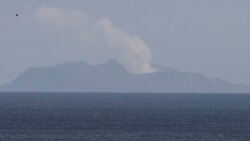 A plume of steam is seen above White Island early morning off the coast of Whakatane, New Zealand, Tuesday, Dec. 10, 2019. (AP Photo/Mark Baker)