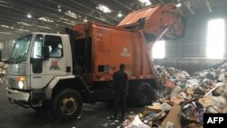 Trucks deliver trash and recycling waste at the District of Columbia’s Fort Totten Transfer Station in Washington, DC, on July 10, 2018.