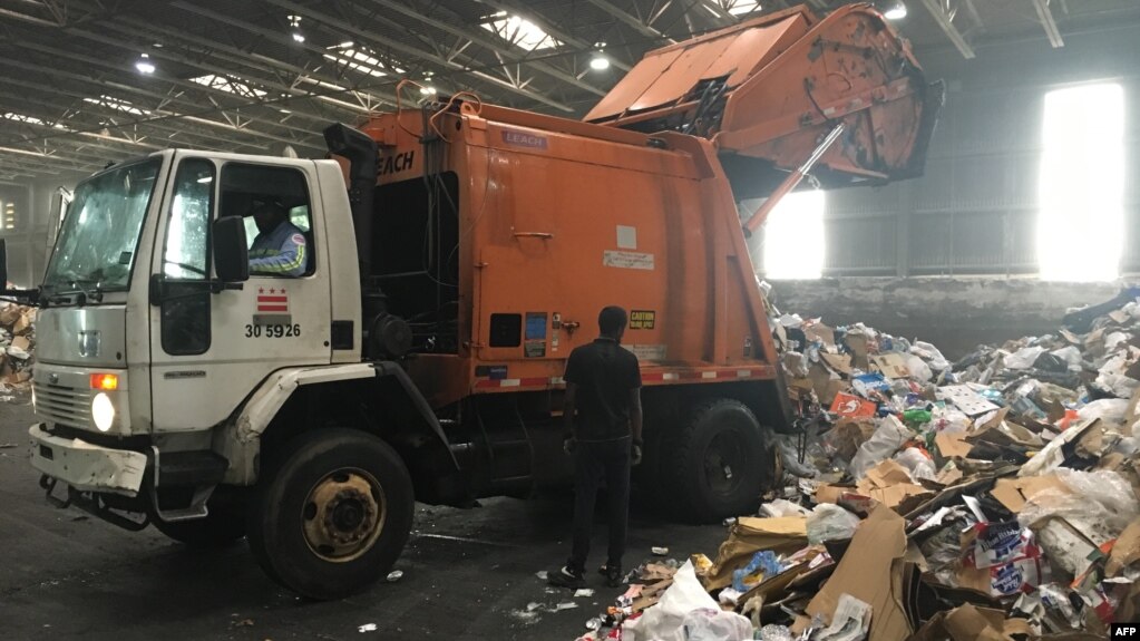 Trucks deliver trash and recycling waste at the District of Columbia’s Fort Totten Transfer Station in Washington, DC, on July 10, 2018. (Photo by Ivan Couronne / AFP)