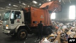 Trucks deliver trash and recycling waste at the District of Columbia’s Fort Totten Transfer Station in Washington, DC, on July 10, 2018. (Photo by Ivan Couronne / AFP)