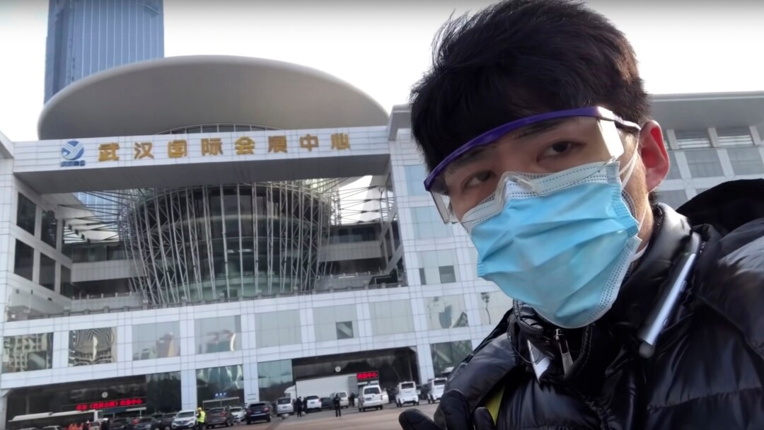 中国公民记者陈秋实2月4日发布的视频的截图显示他站在武汉一处会展中心改造成的临时医院外。