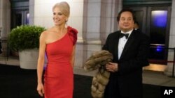 FILE - President-elect Donald Trump adviser Kellyanne Conway, accompanied by her husband, George, speaks with members of the media, Jan. 19, 2017, as they arrive for a dinner at Union Station in Washington, the day before Trump's inauguration.