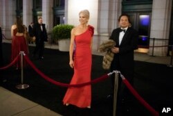 FILE - President Donald Trump adviser Kellyanne Conway, accompanied by her husband, George, speaks with members of the media, Jan. 19, 2017, as they arrive for a dinner at Union Station in Washington, the day before Trump's inauguration.
