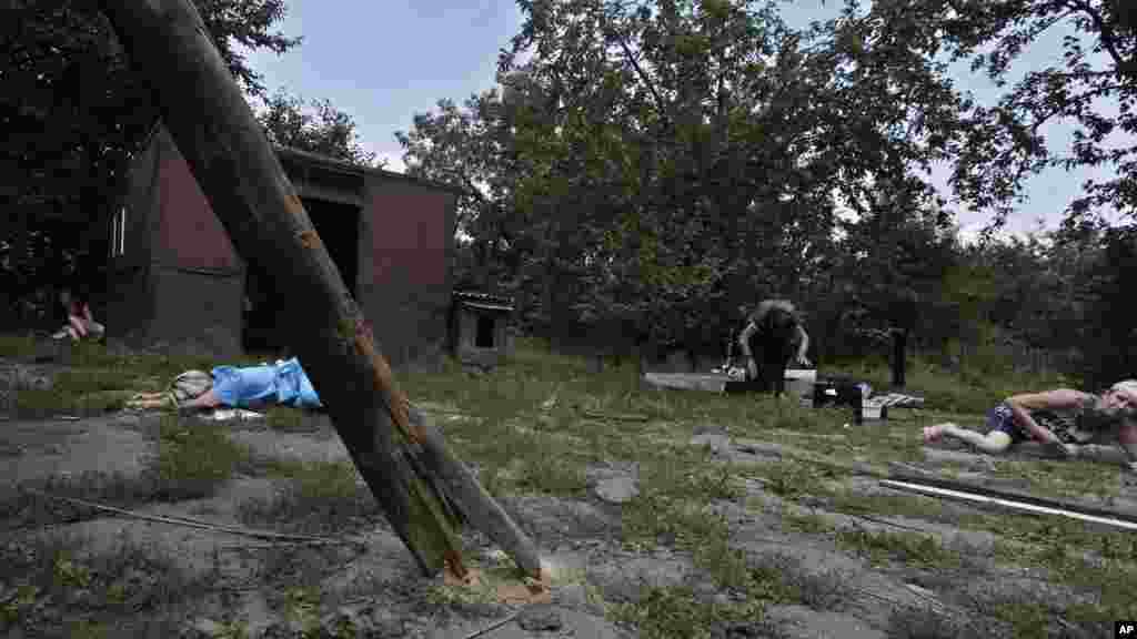 People get onto the ground during incoming shelling in Donetsk, eastern Ukraine, Aug. 10, 2014. 