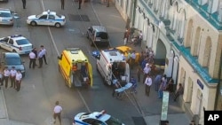 In this image provided by the Moscow Traffic Control Center Press Service, ambulance and police work at the site of an incident in which a taxi struck pedestrians on a sidewalk near Red Square in Moscow, June 16, 2018.