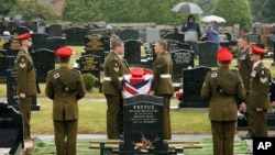 British soldiers from the Light Dragoons lay to rest their fallen colleague, Lance Corporal Nigel Moffett, during a burial service in Belfast (file photo).