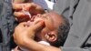 FILE - In this May 28, 2013 photo, Somali vaccination workers give an anti-polio drop to a child, in Mogadishu. Somalia. 