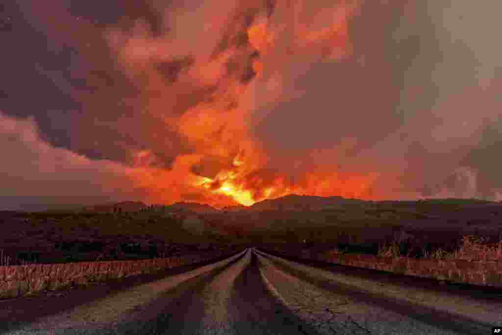 A glowing river of lava flows from the slopes of Mt Etna, Europe&#39;s largest active volcano, near Zafferana Etnea, Sicily, Italy.