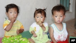 Children eat bread at a nursery in Myongchon County, North Hamgyong province in this handout picture (File)