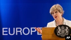 FILE - British Prime Minister Theresa May speaks during a media conference in Brussels, June 23, 2017. May's government is trying to negotiate a trade deal with the EU but Europe wants it to set terms for its leaving the group. 