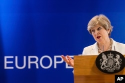 FILE - British Prime Minister Theresa May speaks during a media conference at an EU summit in Brussels, June 23, 2017.