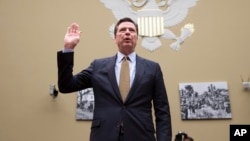 FBI Director James Comey is sworn in on Capitol Hill in Washington, Thursday, July 7, 2016, prior to testifying before the House House Oversight and Government Reform Committee hearing to explain his agency's recommendation to not prosecute Democratic presidential candidate Hillary Clinton over her private email setup. (AP Photo/J. Scott Applewhite)