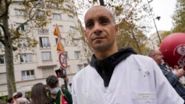 Rachid Ouchem, a medical worker from the Plaisir Hospital, joins a protest gathering outside the Health Ministry in Paris, Tuesday, Sept. 14, 2021 against a law requiring them to get vaccinated by Wednesday or risk suspension from their jobs. (AP Photo/Francois Mori)