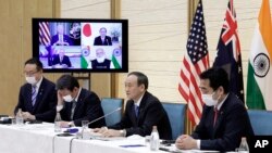 Perdana Menteri Jepang Yoshihide Suga (kedua dari kanan) berbicara dalam pertemuan virtual antara negara negara yang tergabung dalam forum Quad yang melibatkan AS, India dan Australia. Pertemuan virtual tersebut dilaksanakan pada 12 Maret 2021. (Foto: AP/Kiyoshi Ota)