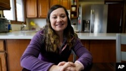 Waukee School District teacher Liz Wagner in her home, Dec. 23, 2021, in Urbandale, Iowa. Teachers have already landed on the front lines of the "culture war." The January 6th incident is no different. (AP Photo/Charlie Neibergall)