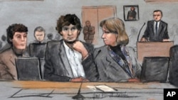 FILE - In this courtroom sketch, Dzhokhar Tsarnaev (c) is depicted between defense attorneys Miriam Conrad (l) and Judy Clarke (r) during his federal death penalty trial, March 5, 2015, in Boston. 