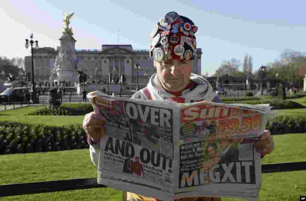 Self-proclaimed royal super-fan John Loughrey reads a tabloid newspaper in London.