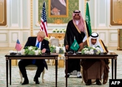 A handout picture provided by the Saudi Royal Palace on May 20, 2017, shows U.S. President Donald Trump and Saudi Arabia's King Salman at a signing ceremony at the Saudi Royal Court in Riyadh.