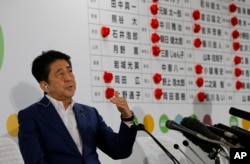 Japan's Prime Minister Shinzo Abe, leader of the Liberal Democratic Party, answers a question from reporters at their party headquarters in Tokyo, July 10, 2016.