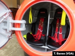 The capsule's seats have shoulder harnesses and seat belts to buckle in tight.