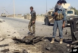 Afghanistan's security forces inspect the site of a U.S. airstrike in Kunduz city, north of Kabul, Afghanistan, Oct. 1, 2015.