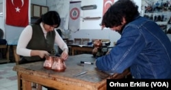 Australian tourists learning to become coppersmiths in Gaziantep, southeastern Turkey