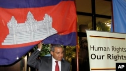 U.N. special rapporteur Surya Subedi walks through a Cambodian national flag upon his arrival in a conference room of U.N. headquarter in Phnom Penh, Cambodia in 2010.