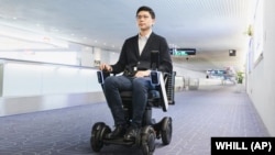 This photo provided by WHILL, Inc., shows the trial of the company's Autonomous Drive System at Haneda Airport in Tokyo in November, 2019.