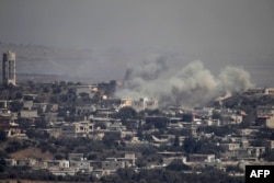 A picture taken from the Israeli-annexed Golan Heights shows smoke rising from the Syrian village of Jubata al-Khashab, Sept. 10, 2016. Israeli aircraft struck Syrian army positions Sept. 10 after fire from war-torn Syria hit the Israeli-held zone of the Golan Heights earlier in the day, the Israeli military said.