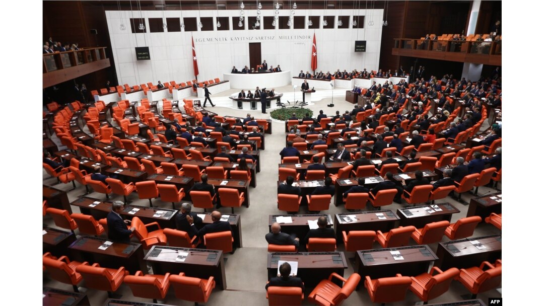 FILE - Turkish MPs and ministers attend a debate as the parliament reconvenes after a summer recess in Ankara, Oct. 1, 2015.