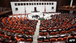 FILE - Turkish MPs and ministers attend a debate as the parliament reconvenes after a summer recess in Ankara, Oct. 1, 2015. 