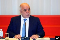 FILE - Iraq's Prime Minister Haider al-Abadi delivers a speech at the opening ceremony of the expert level of the international conference on Iraqi economic development in Tokyo, Thursday, April 5, 2018.
