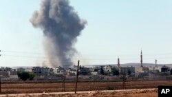 Smoke rises after an airstrike in Kobani, Syria.