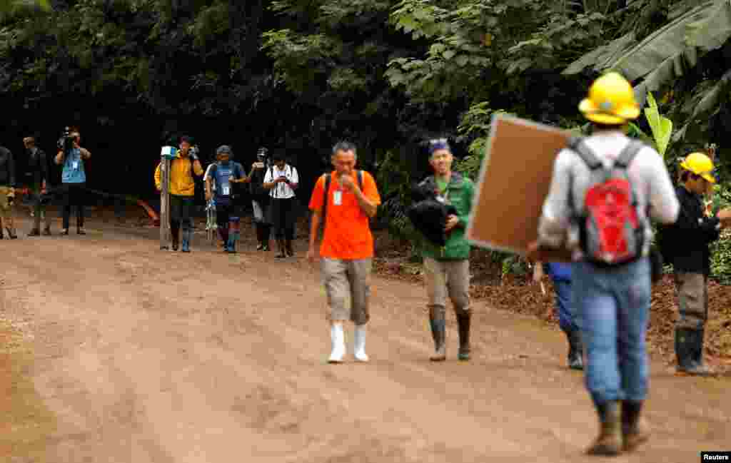 Journalists leave the site of the Tham Luang cave complex after Thailand's government instructed members of the media to move out urgently, in the northern province of Chiang Rai, July 8, 2018.