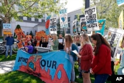 Protesters gather outside the Utah Governor's Energy Summit at Grand America Hotel, May 30, 2019, in Salt Lake City.