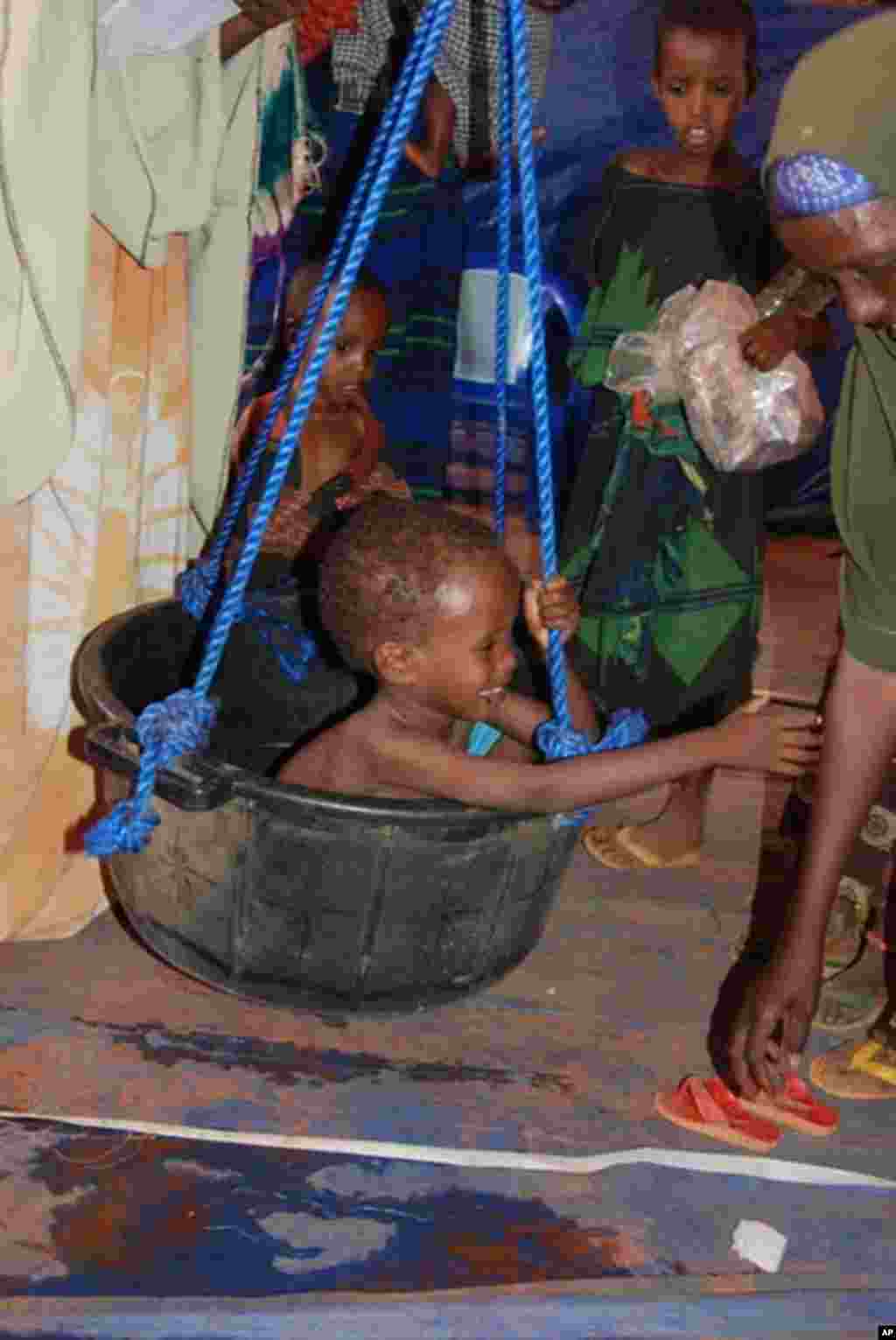 Children are weighed as part of the malnutrition screening process. VOA - P. Heinlein