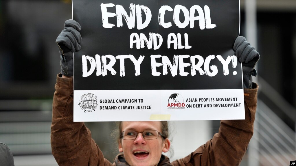 A protester holds a sign demanding to end coal burning during the 23rd Conference of the Parties (COP) climate talks in Bonn, Germany, Nov. 15, 2017.