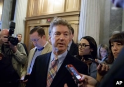 FILE - Sen. Rand Paul, R-Ky., is pursued by reporters on Capitol Hill in Washington, April 7, 2017.