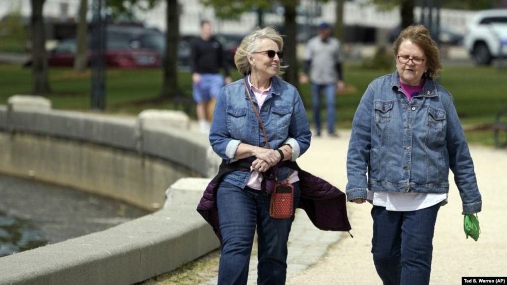 Donna Anderson, left, walks with her friend Christine White, Tuesday, April 27, 2021, in Olympia, Wash. (AP Photo/Ted S. Warren)