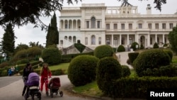 Women push strollers in the park of Livadia Palace where U.S. President Franklin D. Roosevelt, British Prime Minister Winston Churchill and Soviet leader Joseph Stalin held the Yalta Conference in Yalta, Crimea, March 11, 2014. 