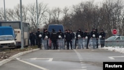 Police guard the road to the Kovilovo sport center hosting the handball match between Serbia and Kosovo, in Belgrade, Serbia, March 23, 2018. The match was later called off.