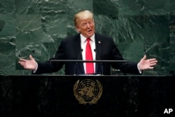 President Donald Trump smiles at reaction from U.N. members during part of his speech..