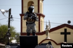 A soldier stands guard after a blockade set by members of the Santa Rosa de Lima Cartel to repel security forces during an anti-fuel theft operation in Santa Rosa de Lima, in Guanajuato state, Mexico, March 6, 2019.